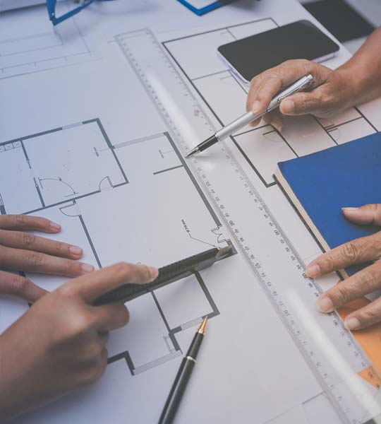 Blueprint-plans-spread-on-table